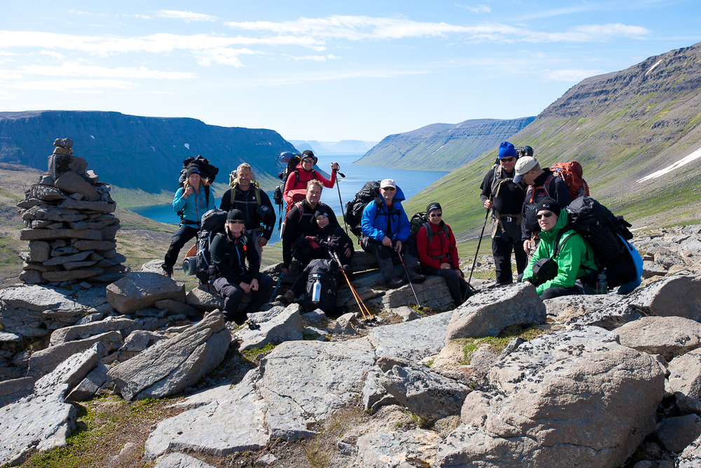 Hiker Group Siting On Stone Formations At Hornstrandir Nature Reserve in Iceland