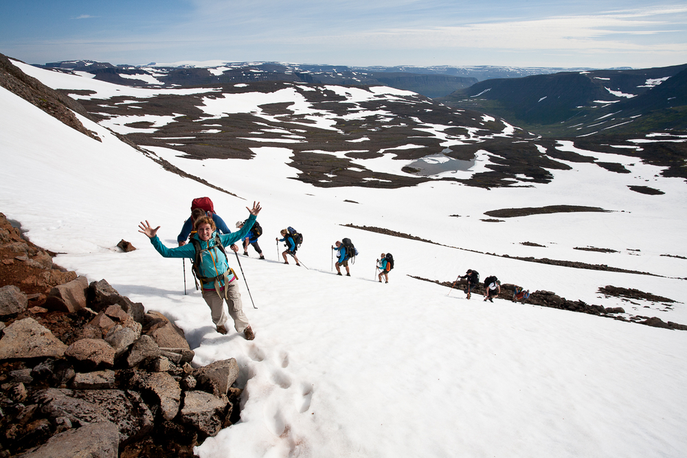 Hikers On A Snowy Hill At Hornstrandir in Iceland