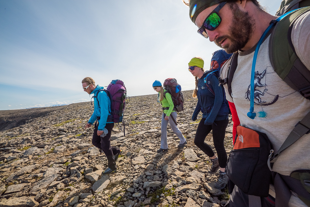 Hikers Walking On A Rocky Ground in Iceland