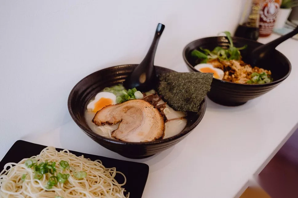 Two bowls of ramen with chashu, soft egg, scallion, and a side of cold noodles in Reykjavík.