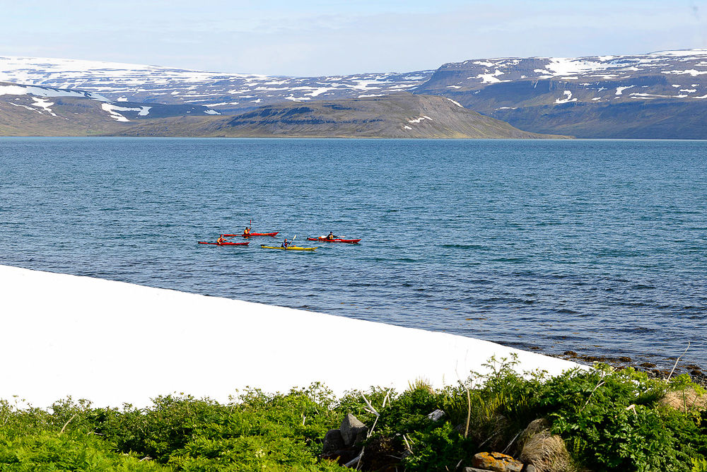 Four Kayaks In The Water With Mountains In The Background in Iceland