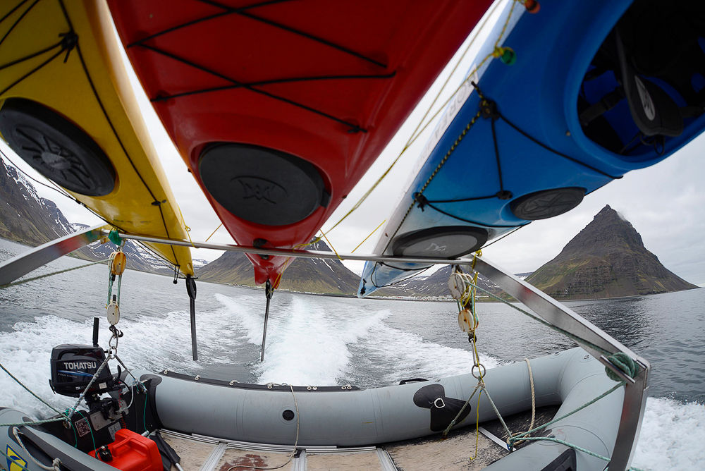 View From The Back Of A Boat With Kayaks Hanging Over Head in Iceland