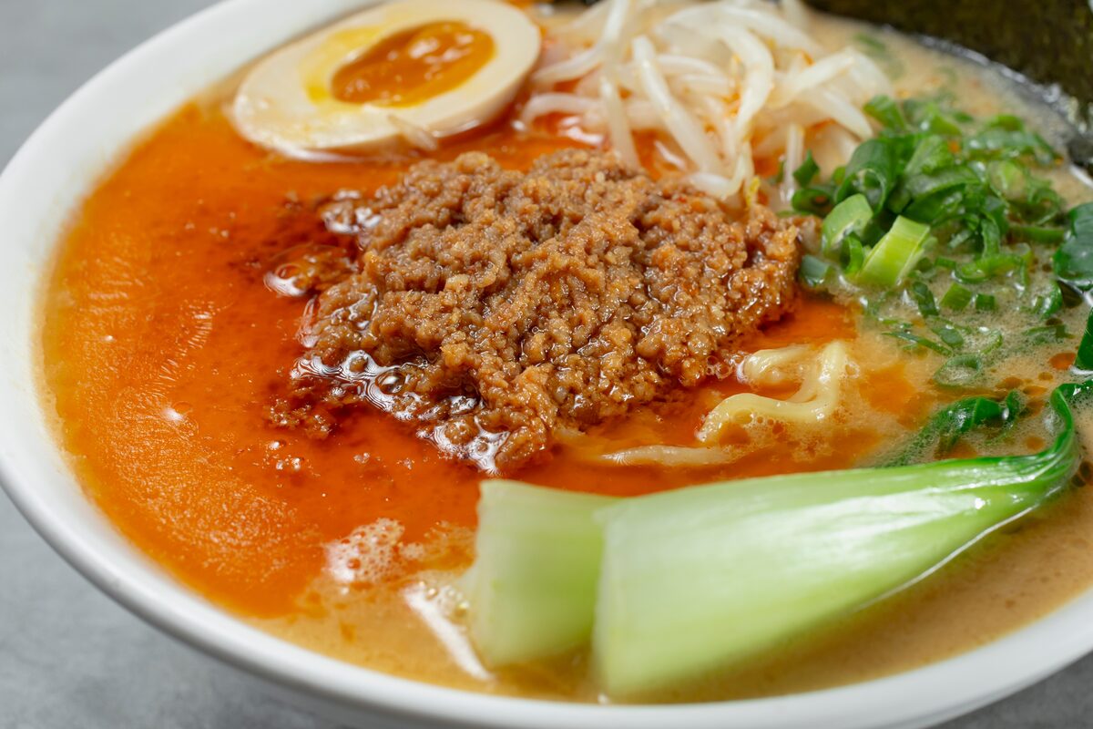 Tantanmen-style ramen with spicy minced pork, soft-boiled egg, bok choy, and bean sprouts.