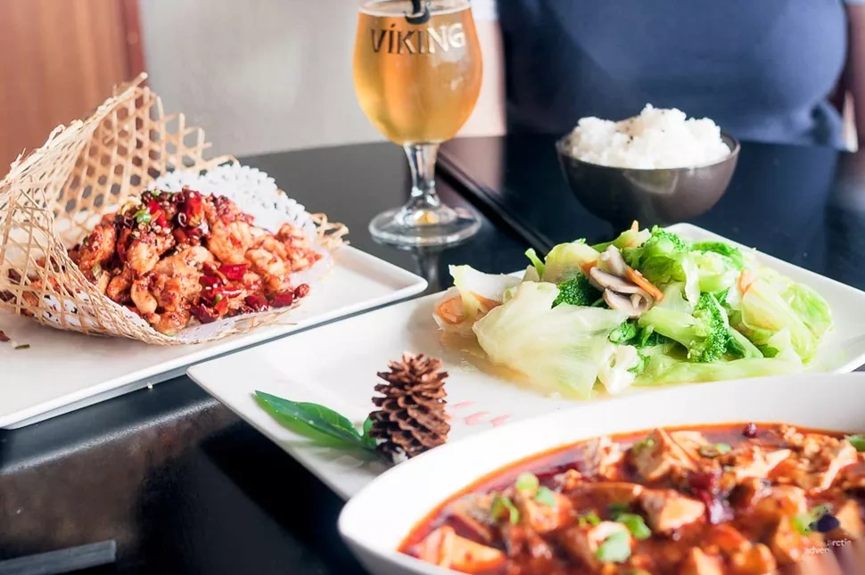 Sichuan spicy chicken in a wire basket and mapo tofu at FINE Restaurant in Reykjavík.