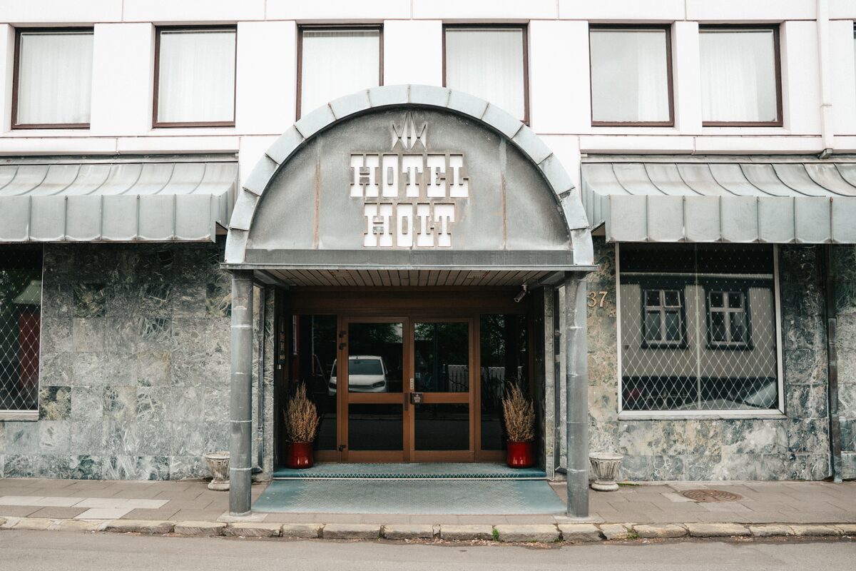 Entrance of Hótel Holt, a hotel with an arched doorway on a quiet street in Reykjavík.
