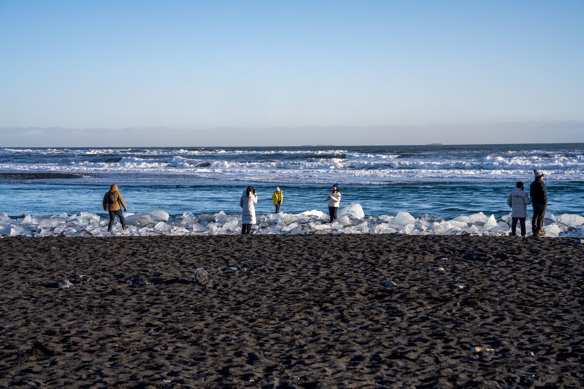 Wide shot of ice, surf, and sky along Diamond Beach coastline.