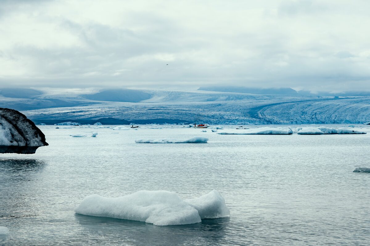 Icebergs floating in Jökulsárlón lagoon with a glacier in the background.