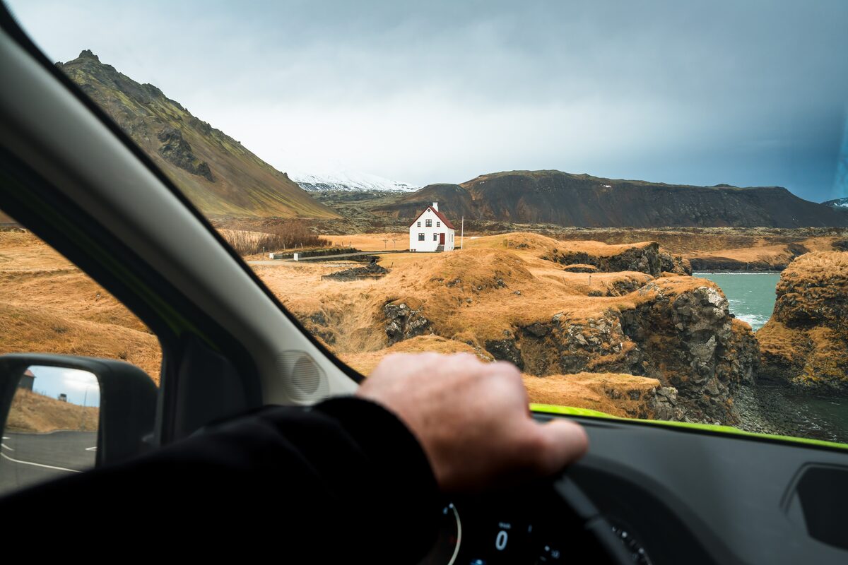 View Of A House From Inside Of A Van In Icelandic Plains in Iceland