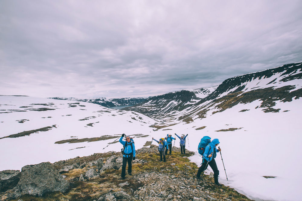 Hikers Between Snowy Mountains in Iceland