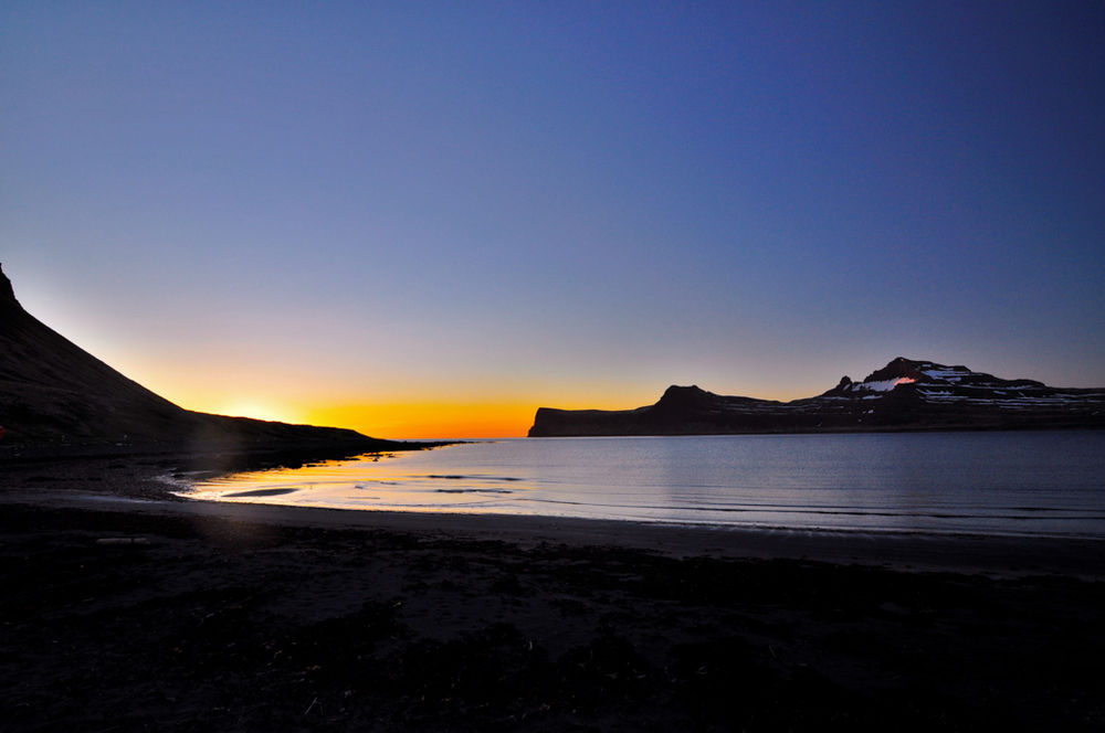 Sunset Over Water Between Mountains in Iceland