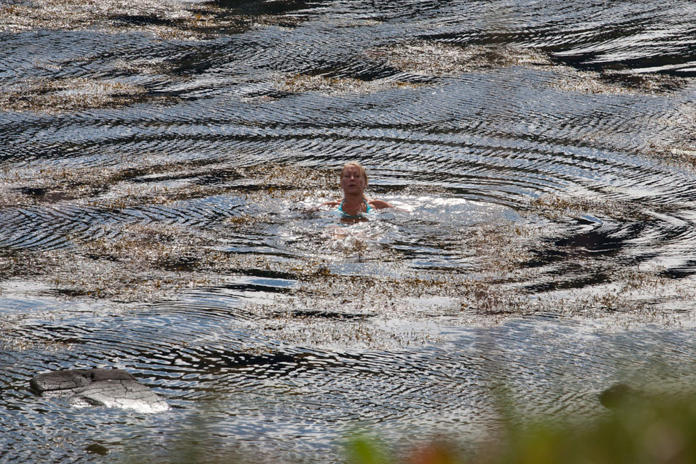 Woman Smiwwing With Ripples Around Her in Iceland