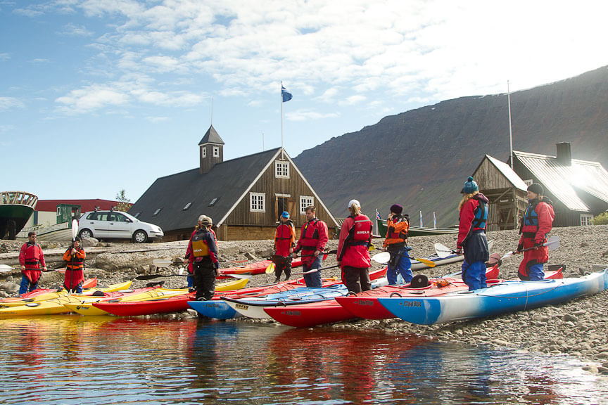 Kayaks With Peoiple On The Shore Before A Kayak Trip in Iceland