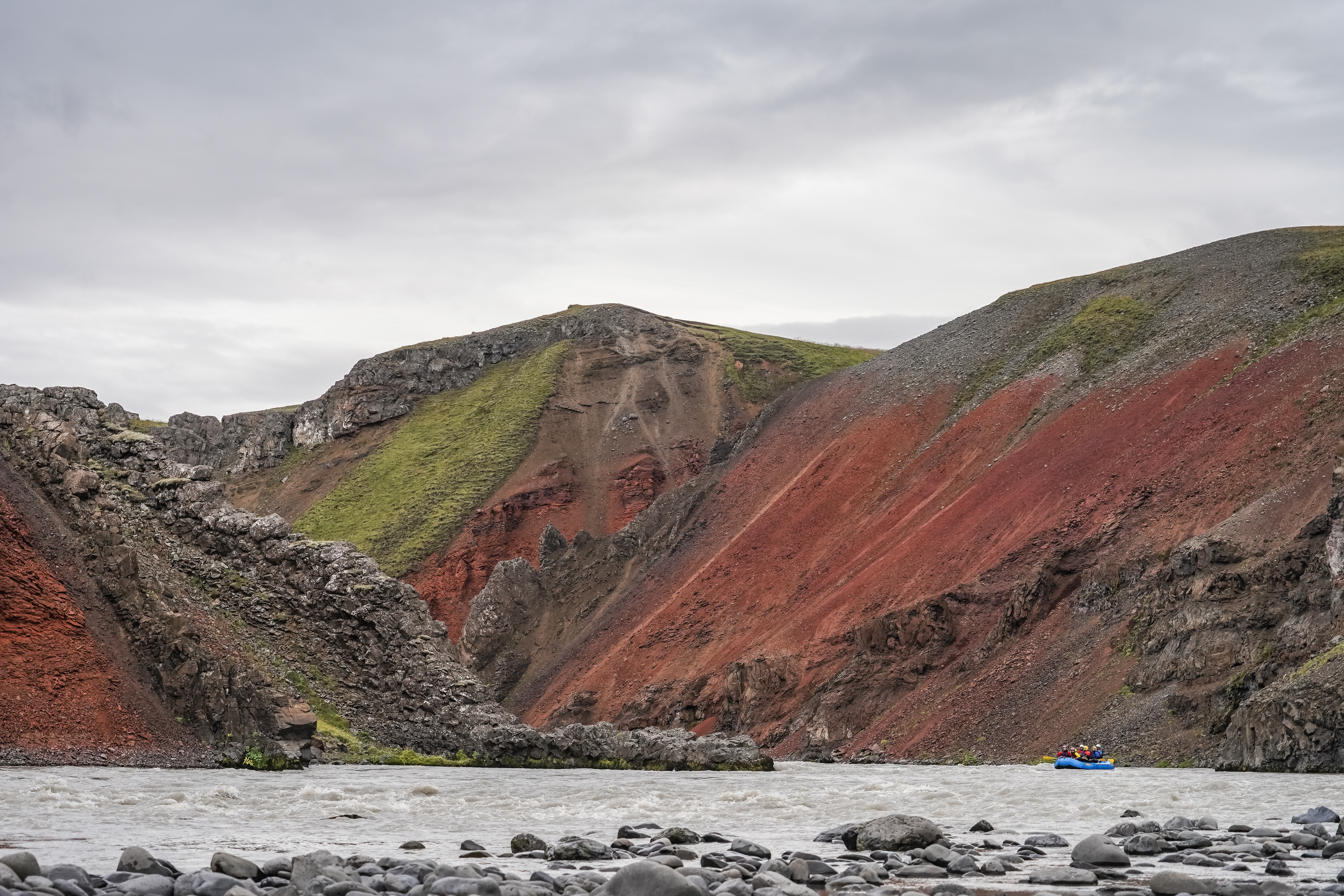 One Rafting Blue Boat Between Mountains On A River in Iceland