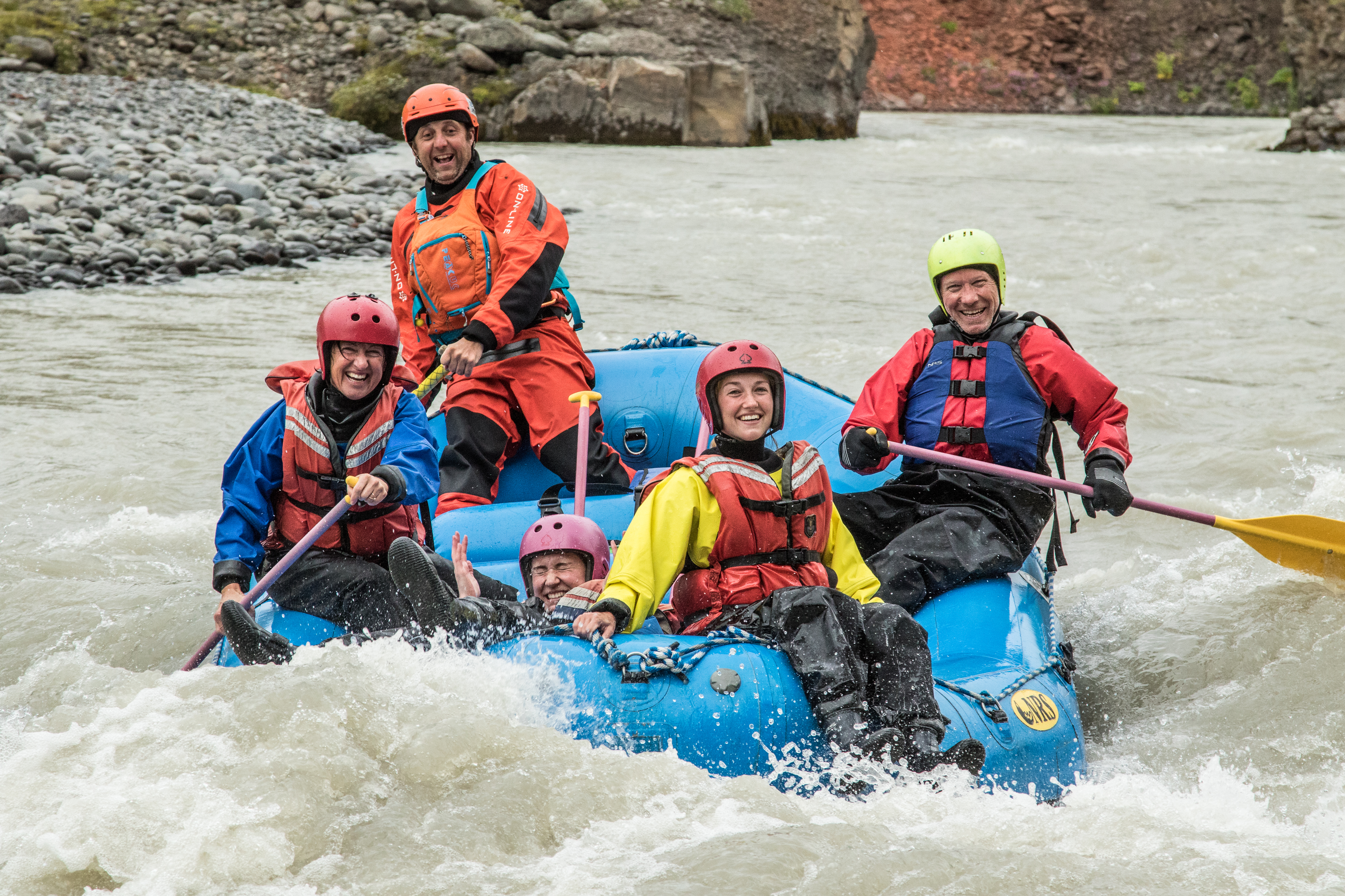 People In A Blue Boat On A Rafting Tour in Iceland