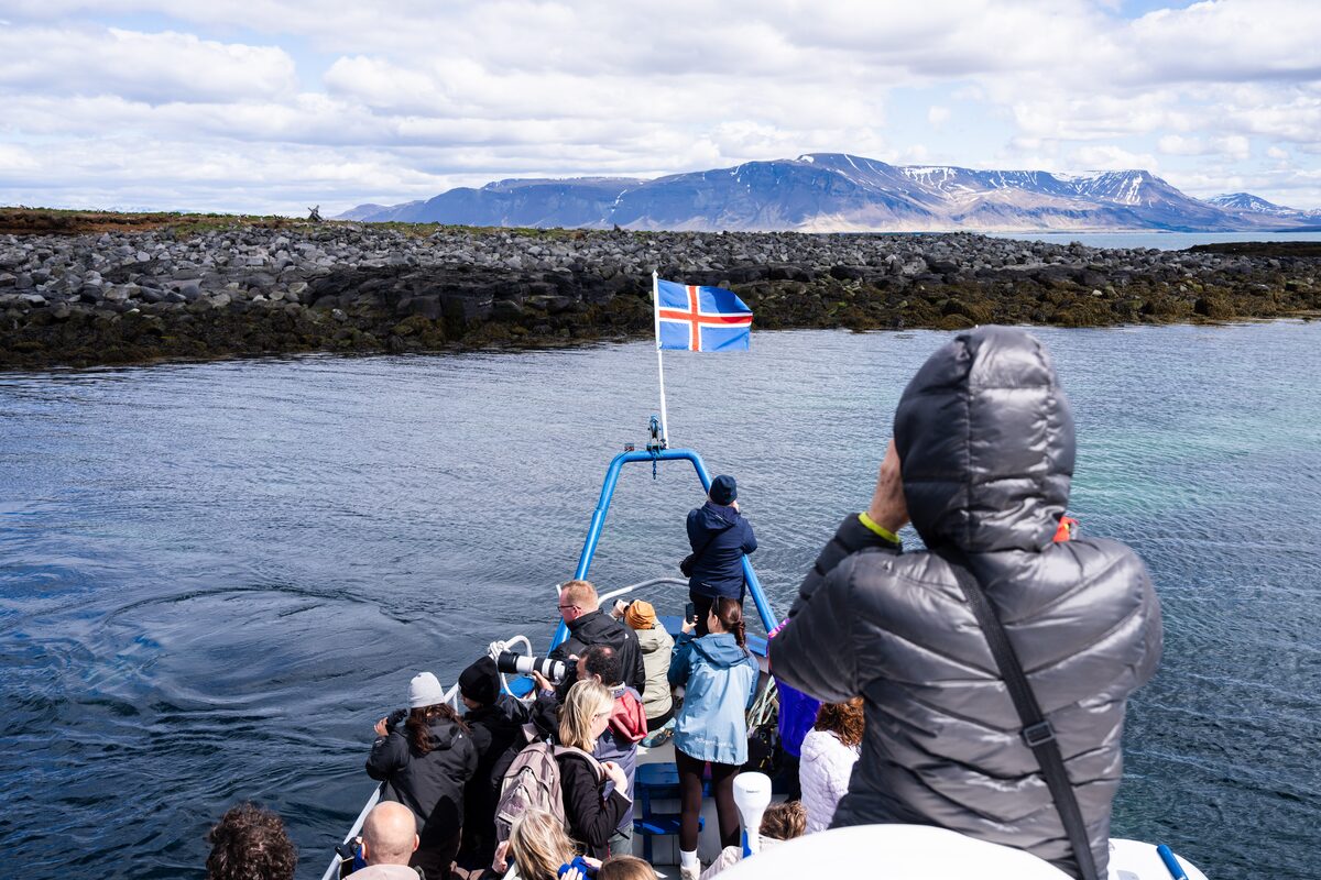People On A Boat Near The Shore in Iceland