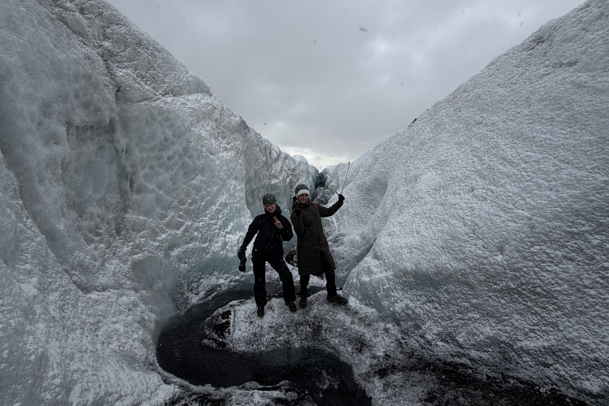 Justyna with a colleague posing on a glacier during a hiking tour on Sólheimajökull in Iceland.