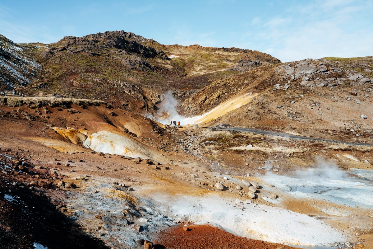 People At Seltun Geothermal Area Looking At Steam in Iceland