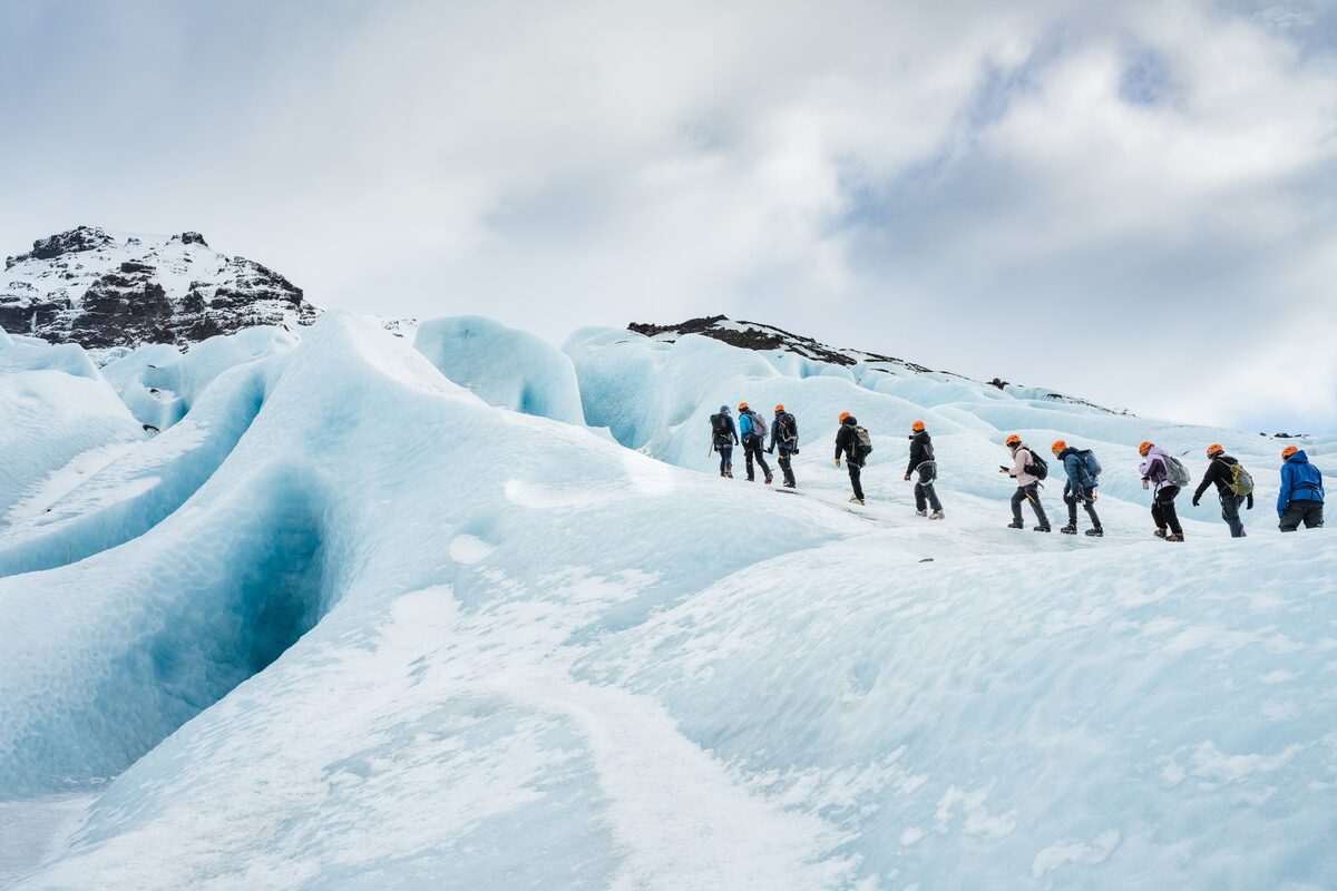 Group Of People Walking Up A Glacier in Iceland