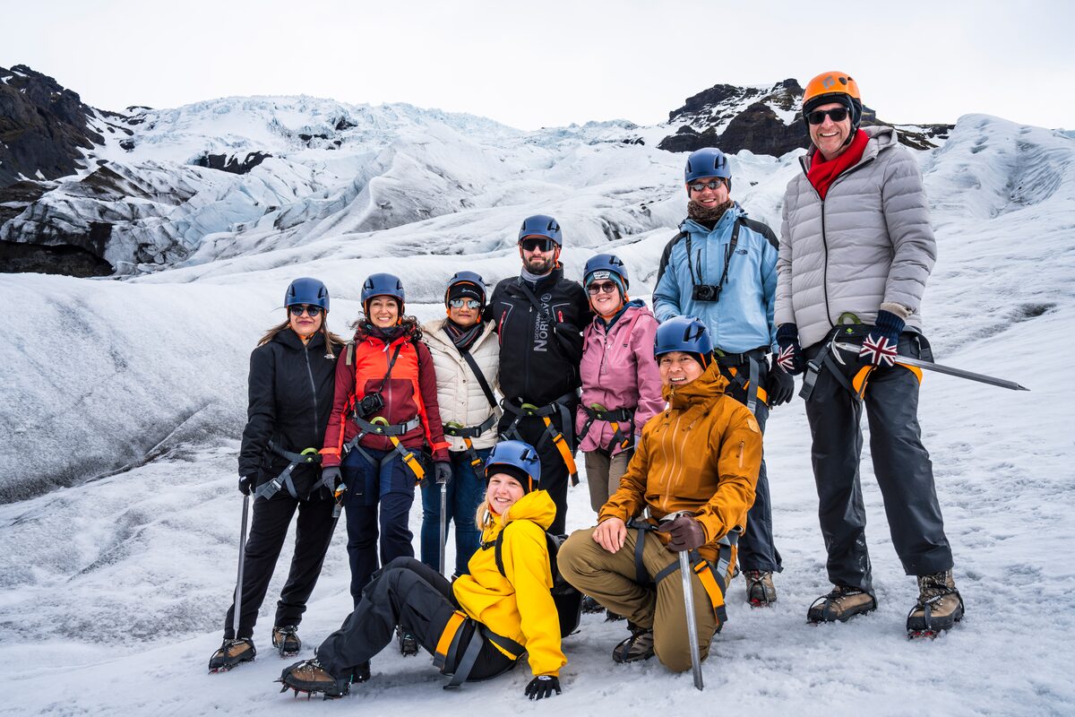 Group Of Tourists On A Glacier Hike Posing For A Picture in Iceland