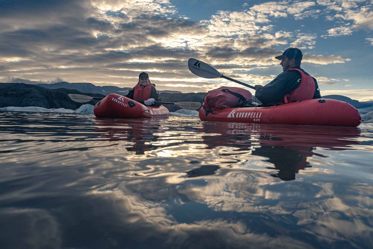 A Couple In Red Kayaks In Fjallsarlon Glacier Lagoon in Iceland