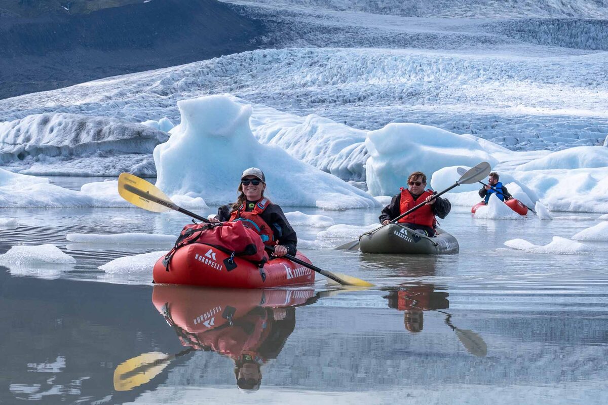 Three Kayaks In Water With A Glacier Behind Them in Iceland