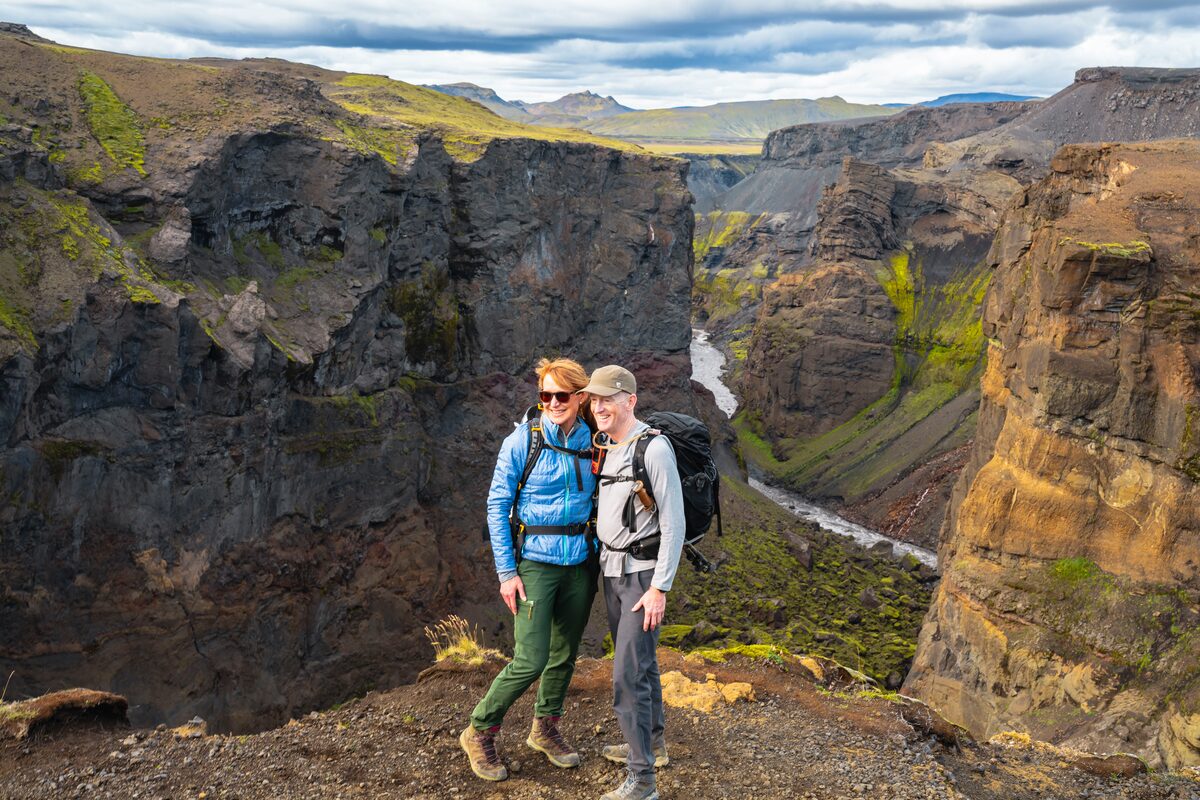 A Couple On A Ledge Posing For Camera in Iceland