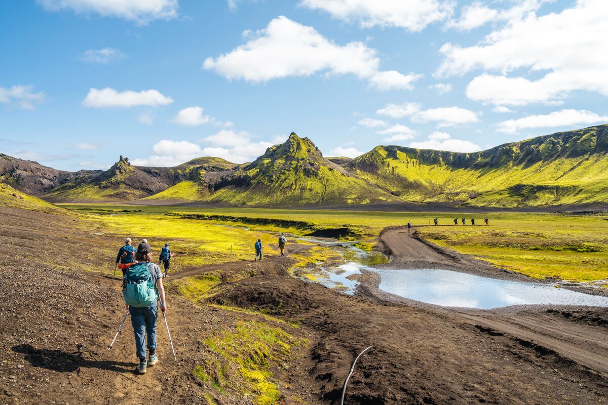 Hikers Walking Near Mountains At Landmannalaugar in Iceland