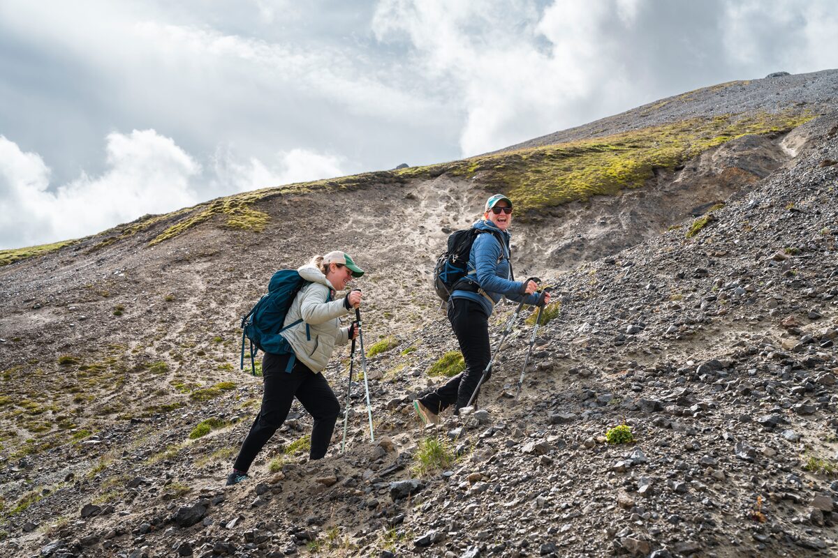 Two Women Hiking Up A Hill At Landmannalaugar in Iceland