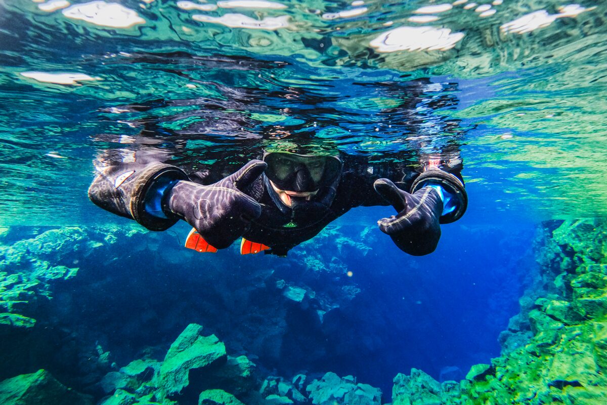 Person In Full Snorkeling Gear Under Water in Iceland