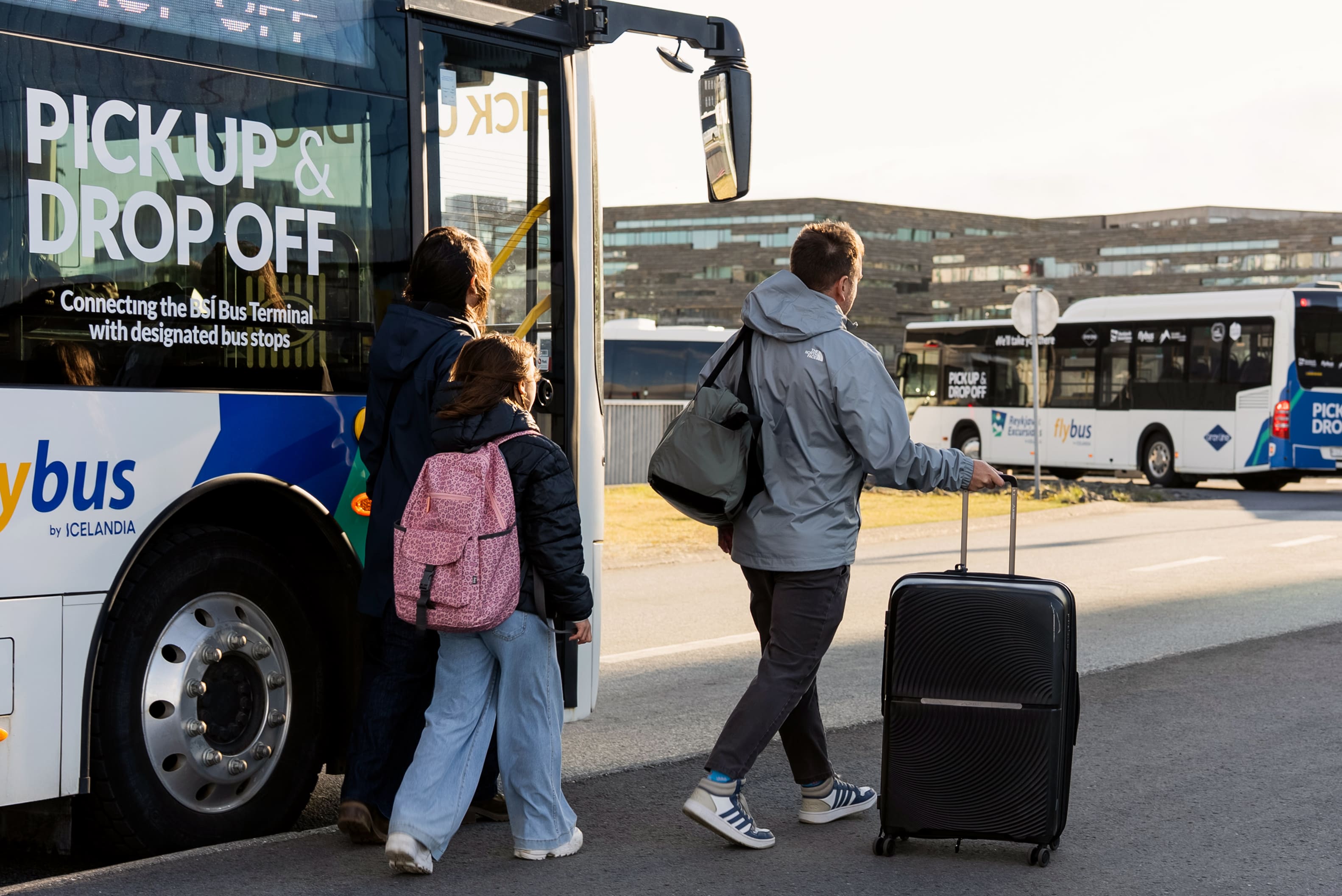 Family Walking Away From A Flybus Bus in Iceland