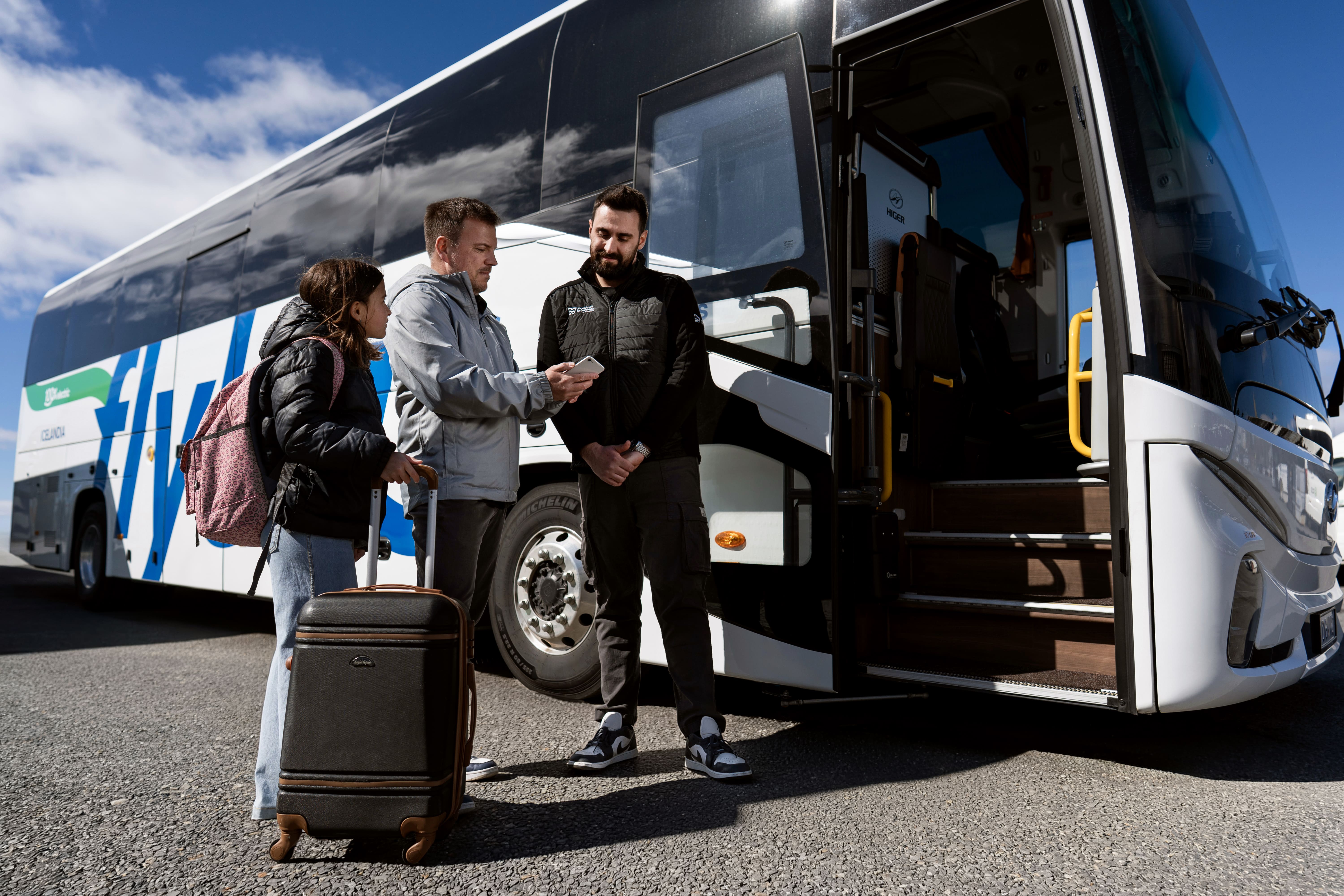 Father And Daughter Asking For Information From The Bus Driver Near The Flybus Bus in Iceland
