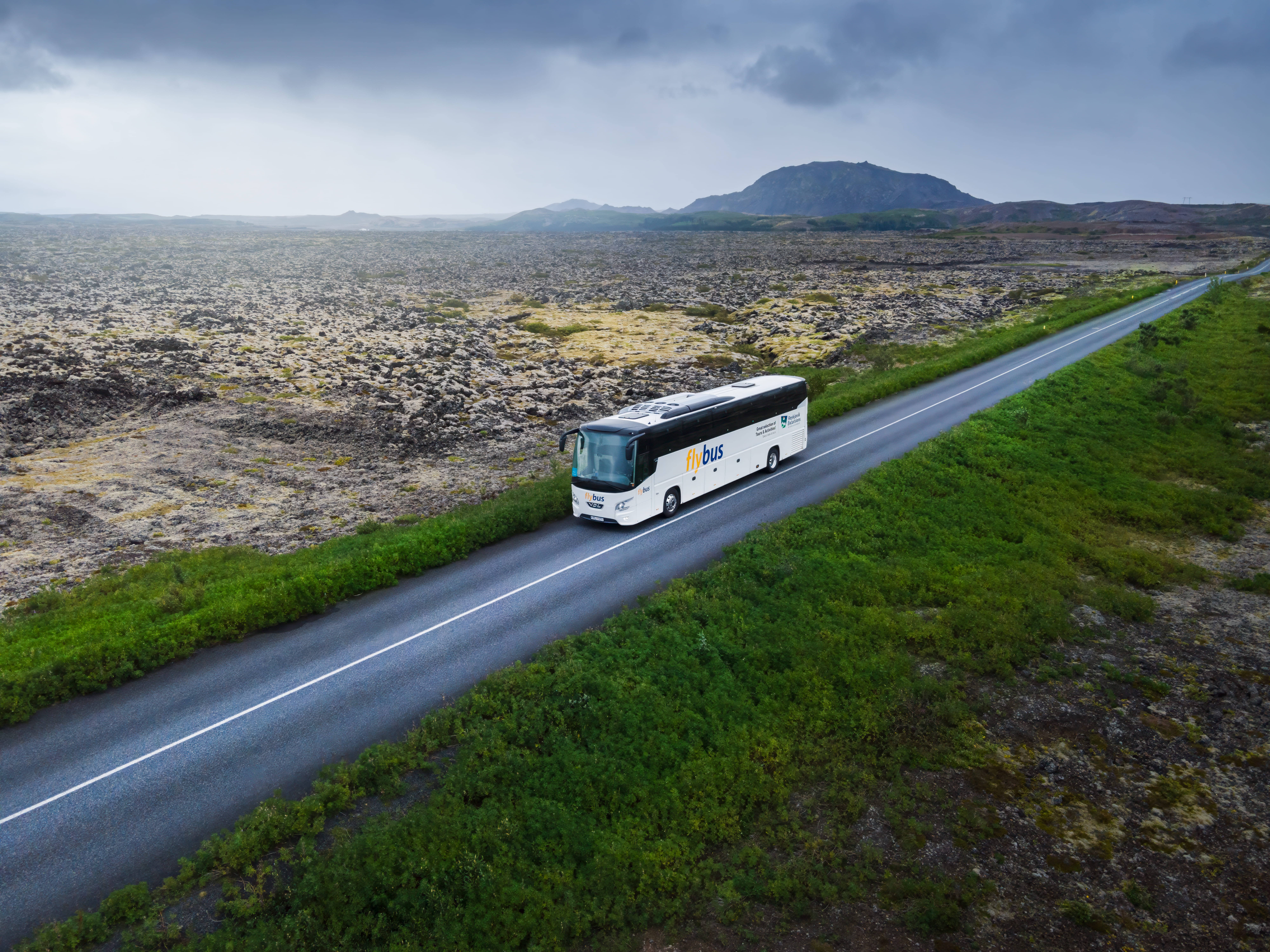 Flybus Driving On The Road Near Lava Fields in Iceland