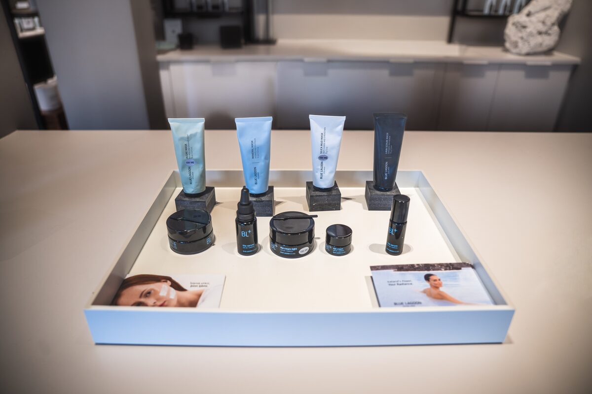 Blue Lagoon skincare products, tubes and jars, arranged on a white display tray in a shop.