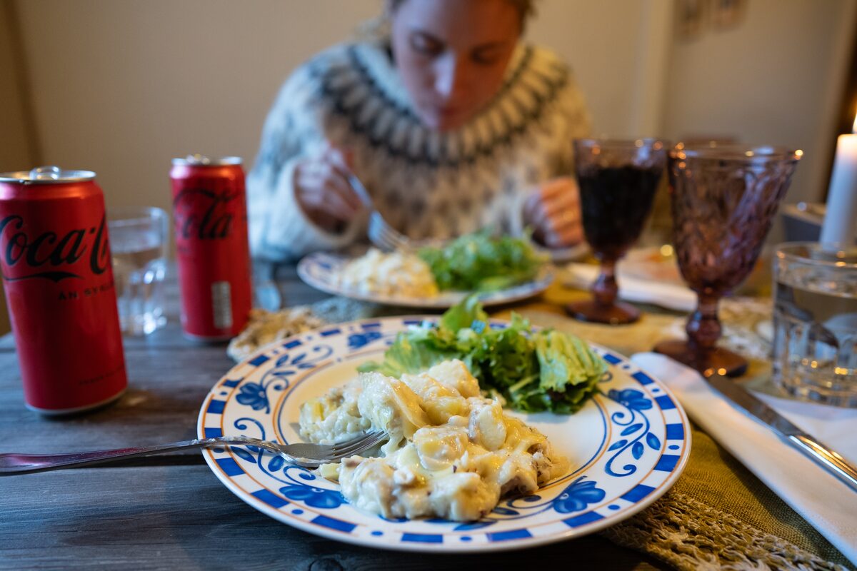 Plate of plokkfiskur with fresh salad on a wooden table.