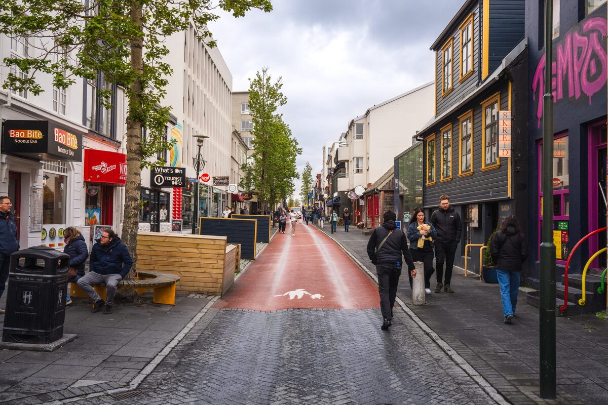 People walking along Reykjavík's Laugavegur past shops and cafés.