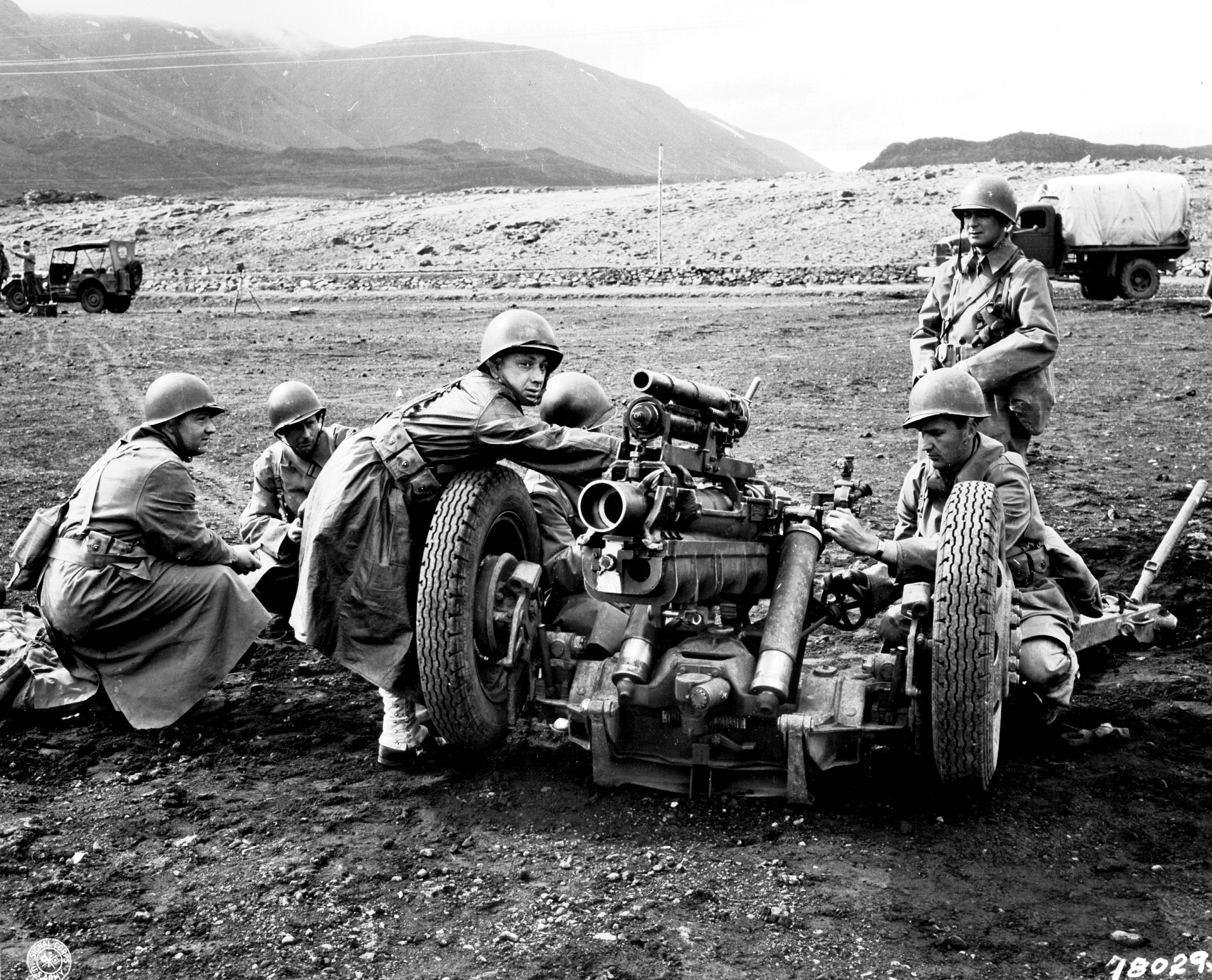 Soldiers around a large gun in Iceland during World War II.