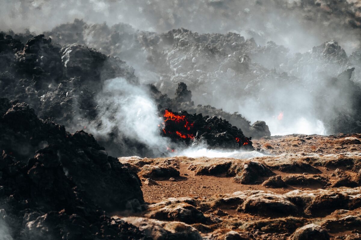 Fresh lava on a Reykjanes fissure in Iceland with steam rising off the flow.