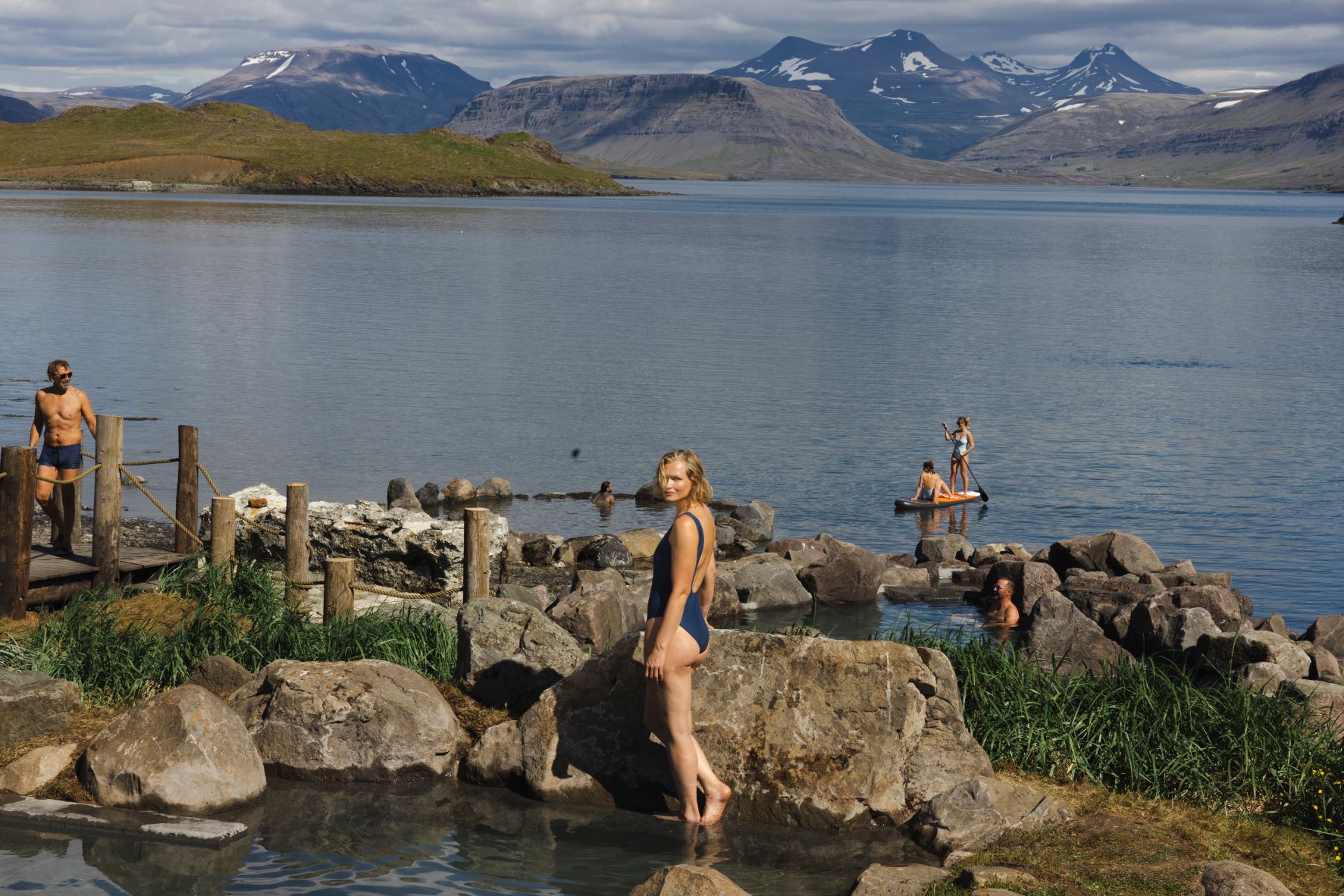 People Enjoying Hvammsvik Hot Springs In June in Iceland