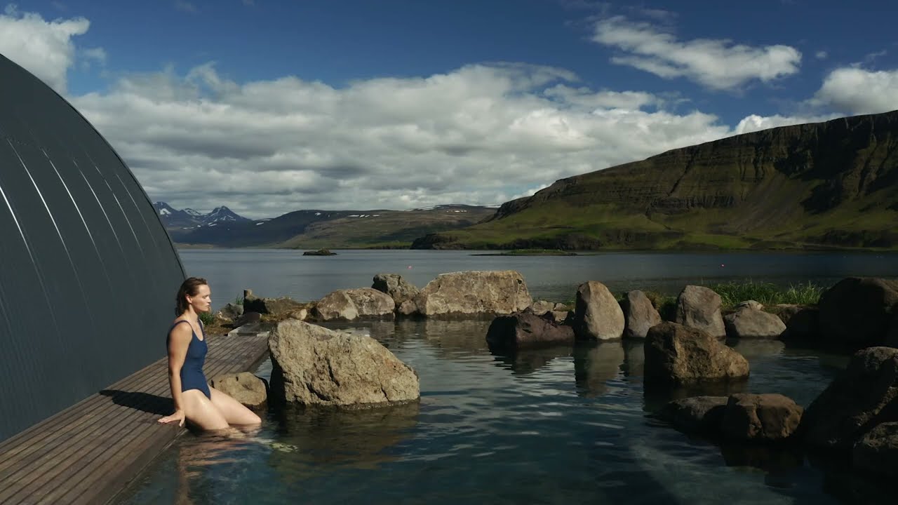 Woman Between Rocks At Hvammsvik in Iceland
