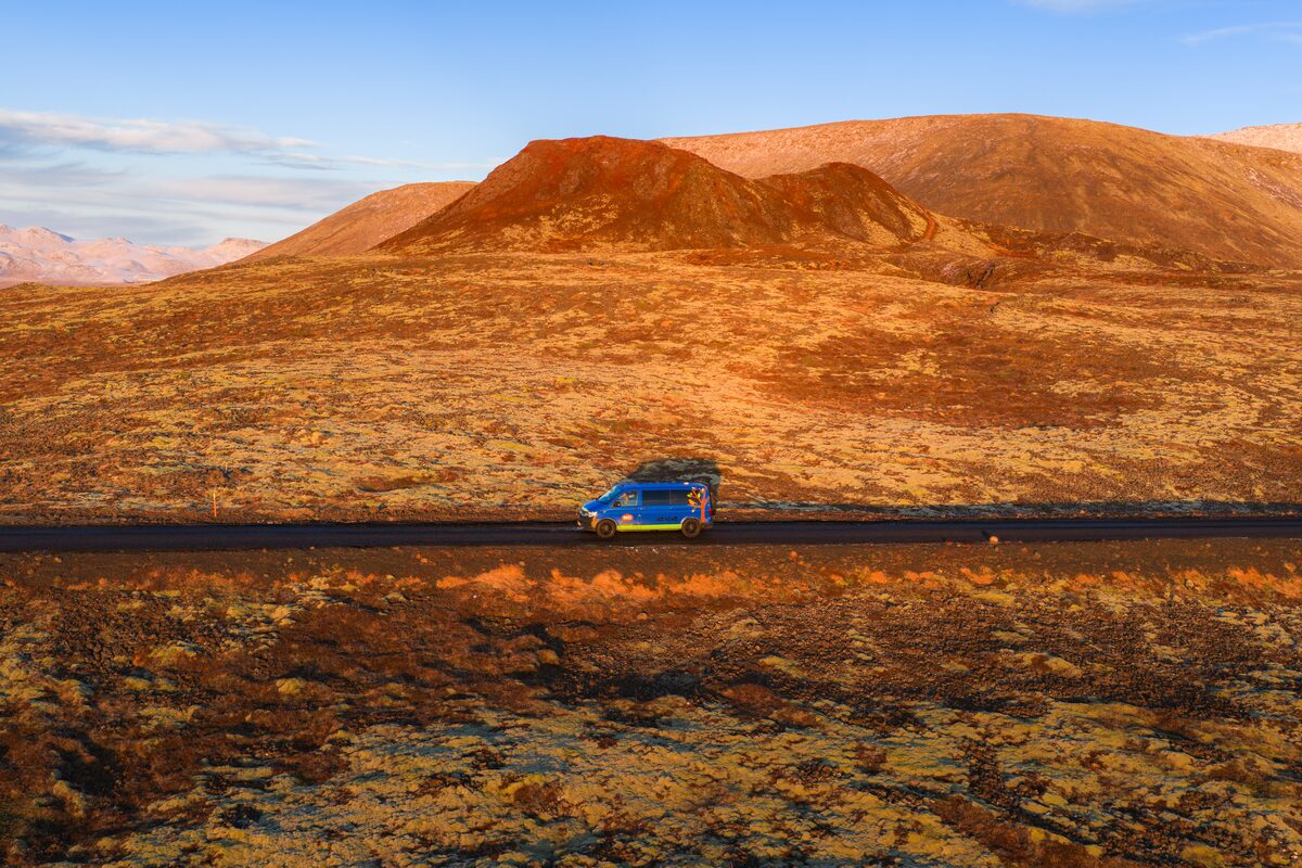 4x4 Campervan driving through autumn Iceland views on a remote road.