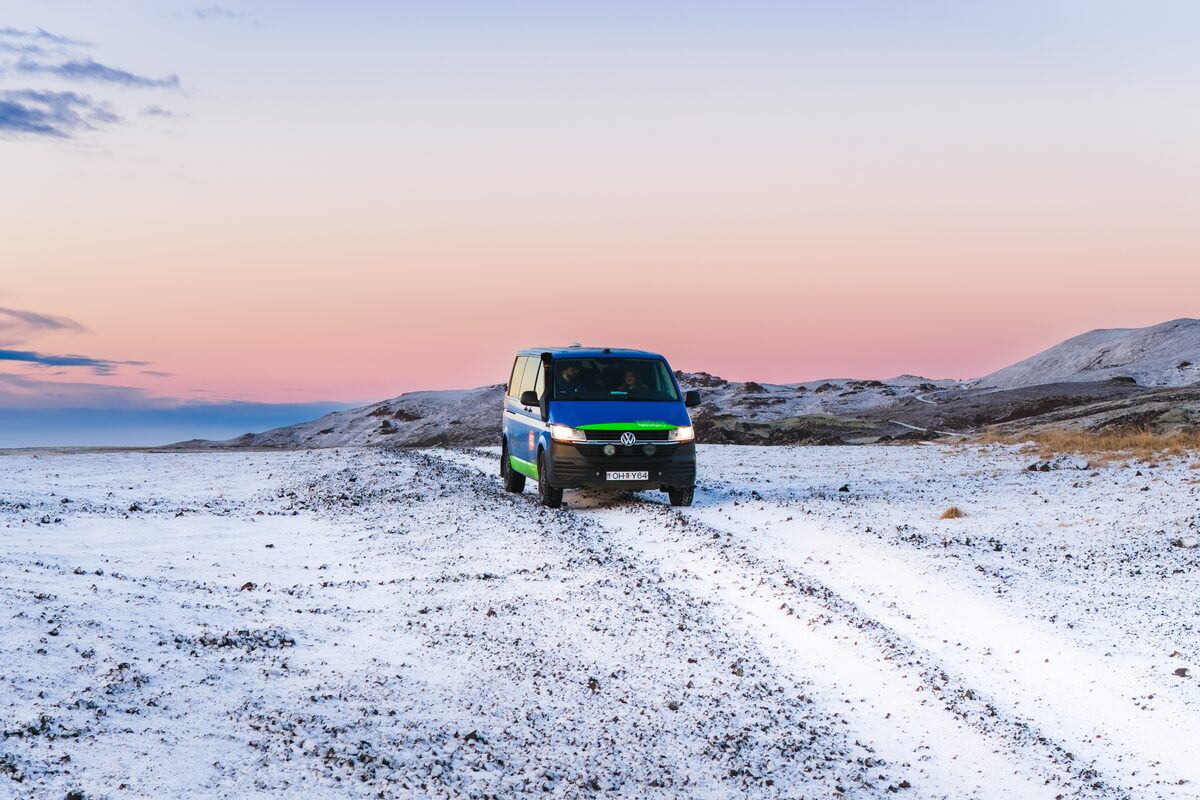 4x4 Campervan parked in snowy scenic spot in Iceland.