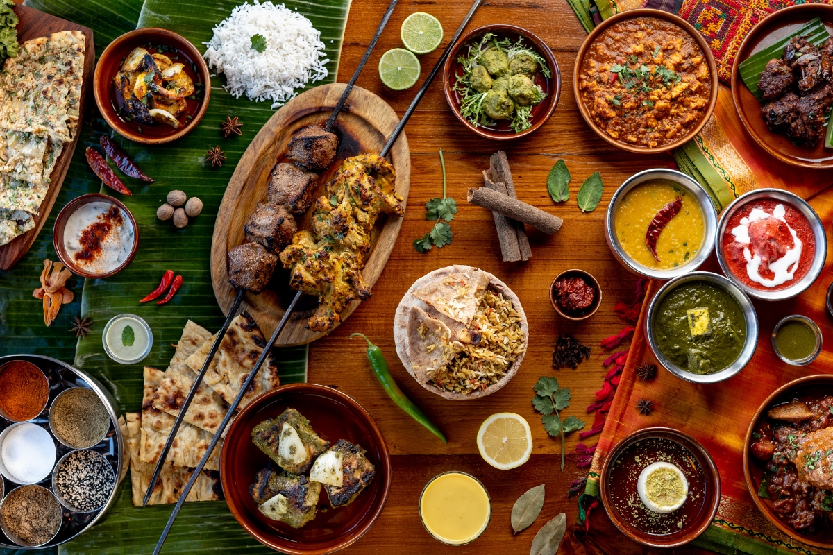 Indian spread at Austur-Indíafjelagið: tandoori skewers, curries, naan, rice, and thali bowls.