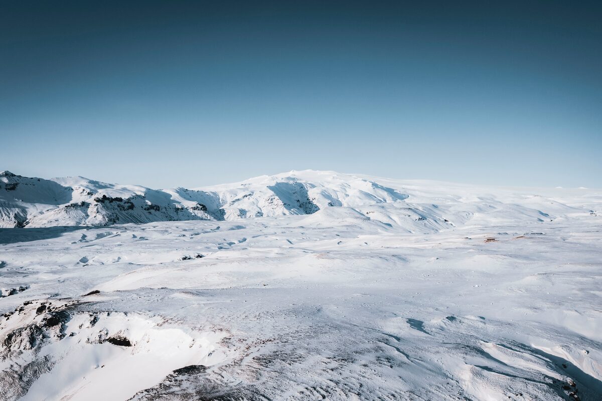 Snow-covered Eyjafjallajökull ice cap under a clear sky.