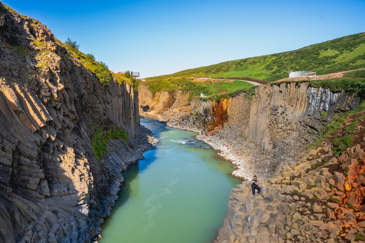 Aerial view of the narrow Studlagil gorge with a green river below