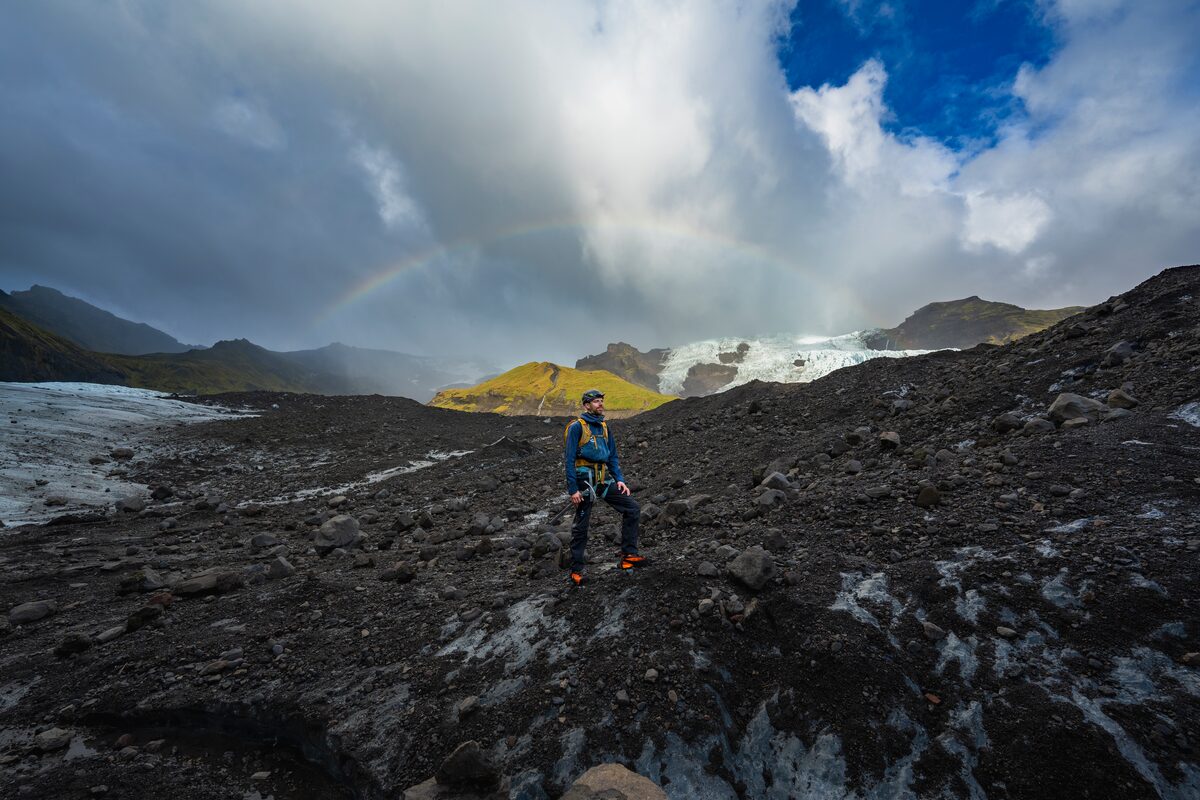 Glacier Hike Guide On Falljokull Glacier Under A Rainbow in Iceland