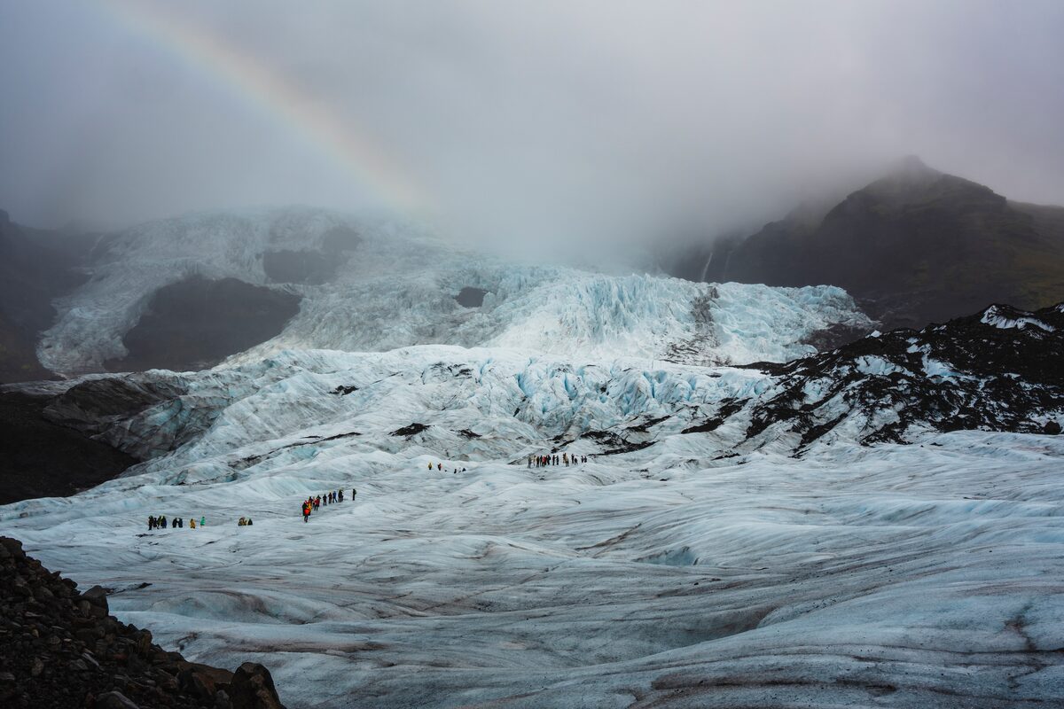 Glacier Hike On Falljokull Glacier With A Rainbow Above in Iceland