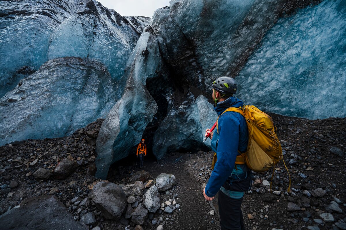 People On A Glacier Hike Near A Fissure In The Glacier in Iceland