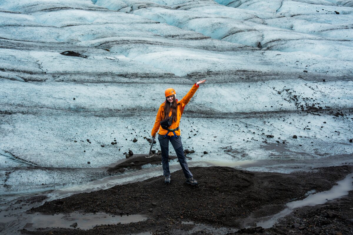Woman In An Orange Jacket On Falljokull Glacier Hike in Iceland