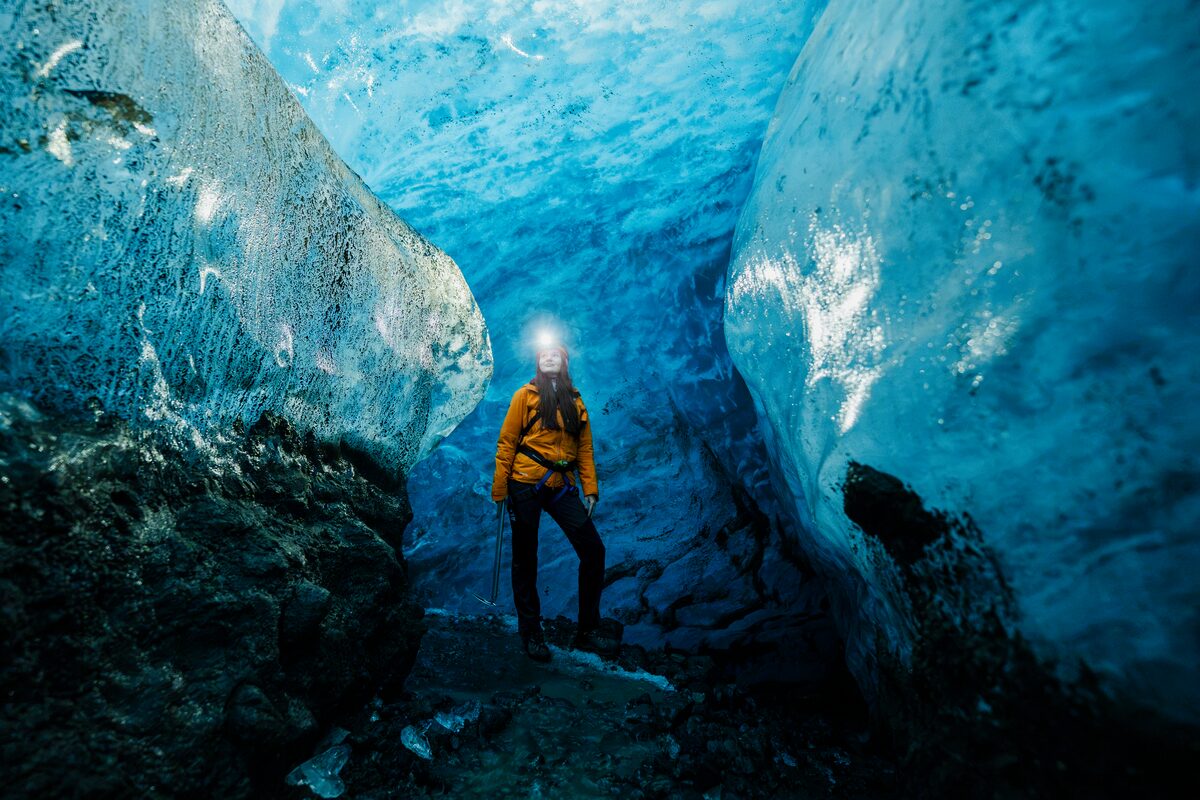 Woman At Blue Ice Cave With Her Headlamp On in Iceland