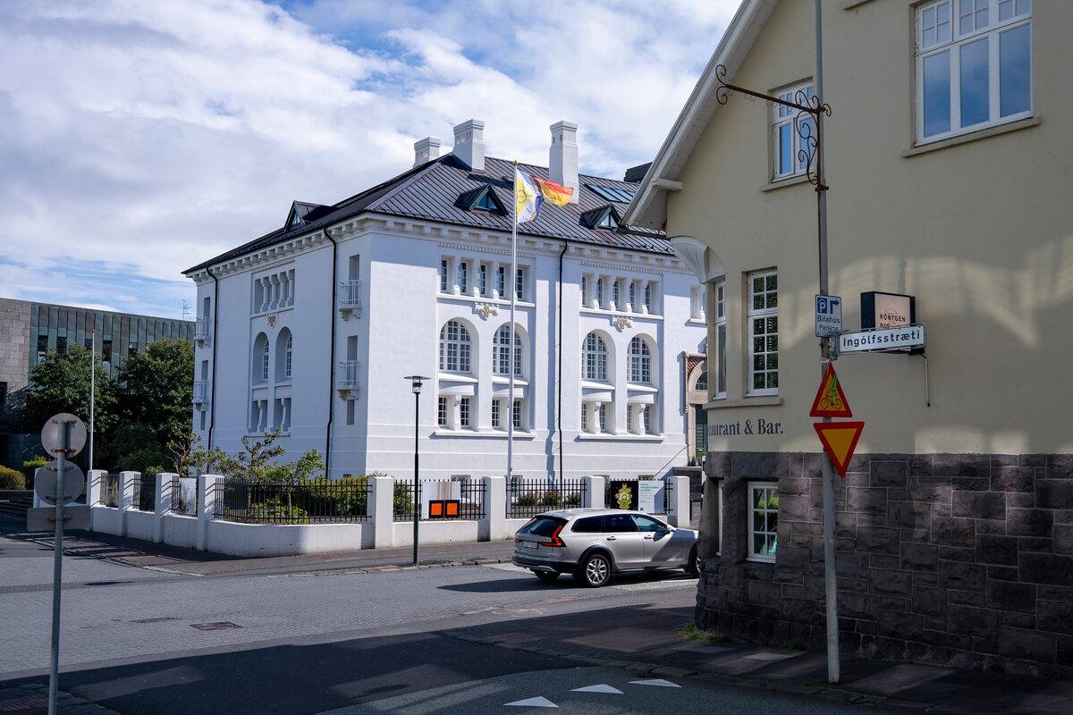 Ingólfsstræti street sign on a Reykjavík corner with historic buildings and a parked car.